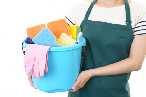 Cleaner maintaining a communal entrance in a Brent apartment block